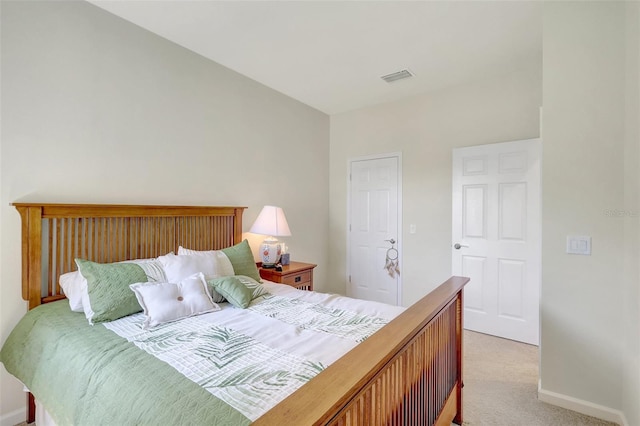 bedroom featuring baseboards, visible vents, and light colored carpet