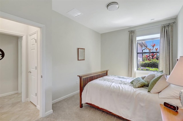 bedroom with baseboards and light tile patterned floors