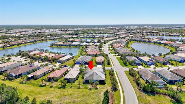 bird's eye view featuring a water view and a residential view