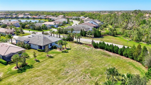 drone / aerial view featuring a water view and a residential view