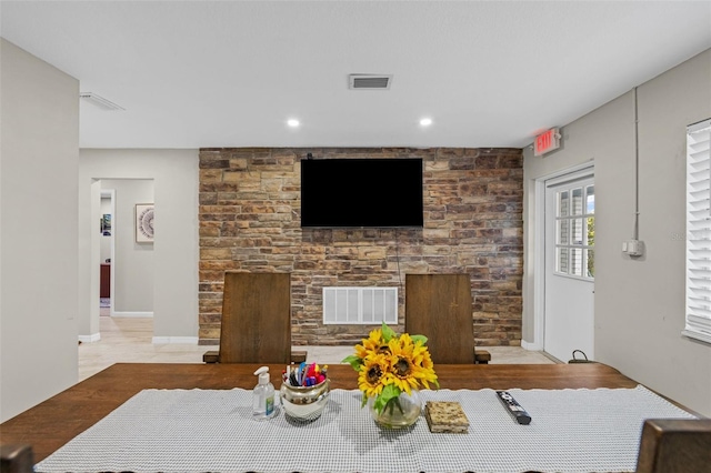 living area featuring a fireplace and visible vents