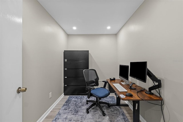 office space with recessed lighting, light wood-type flooring, and baseboards