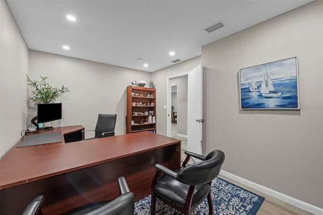 office featuring recessed lighting, visible vents, baseboards, and wood finished floors