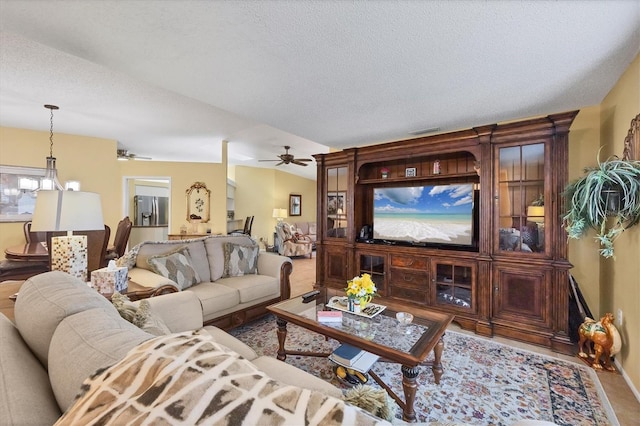5614 Garden Lakes Dr, Bradenton, FL 34203 - living area featuring a textured ceiling, ceiling fan, lofted ceiling, and visible vents