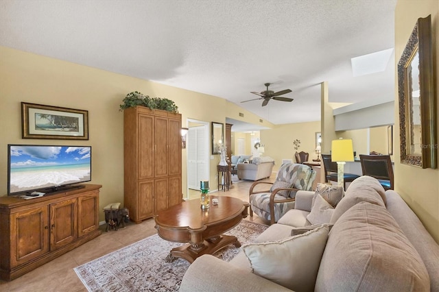 5614 Garden Lakes Dr, Bradenton, FL 34203 - living area featuring ceiling fan, vaulted ceiling, a textured ceiling, and light tile patterned flooring