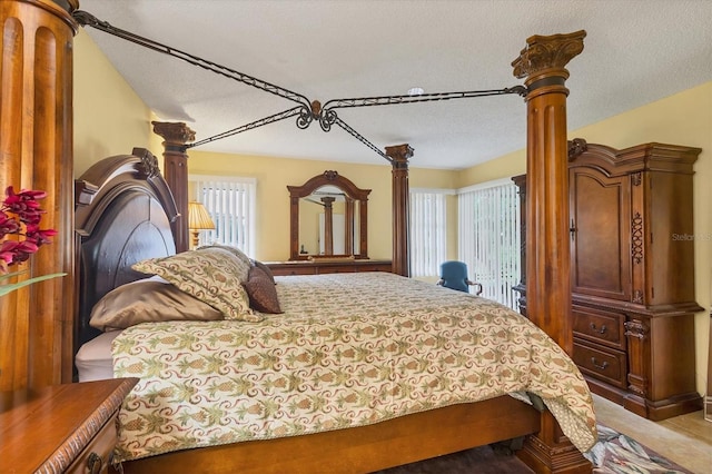 5614 Garden Lakes Dr, Bradenton, FL 34203 - bedroom featuring ornate columns and a textured ceiling