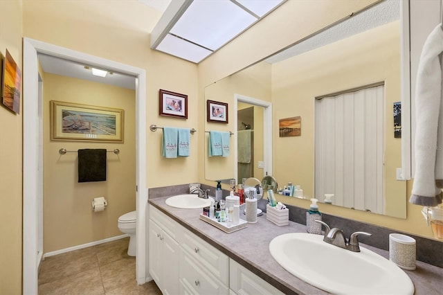 5614 Garden Lakes Dr, Bradenton, FL 34203 - bathroom with a skylight, tile patterned flooring, a sink, and toilet