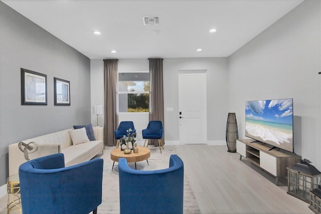 living room featuring recessed lighting, visible vents, baseboards, and wood finished floors