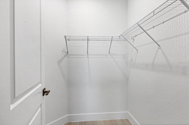 spacious closet with wood finished floors