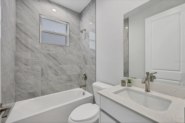 bathroom featuring vanity, toilet, and washtub / shower combination