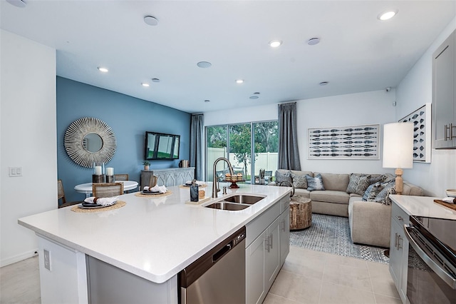 kitchen with open floor plan, light countertops, black electric range, stainless steel dishwasher, and a sink