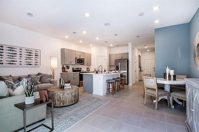 living area featuring light tile patterned flooring and recessed lighting