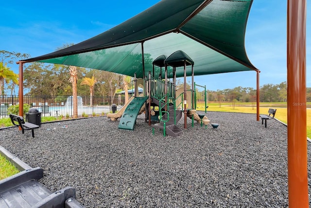 communal playground featuring fence