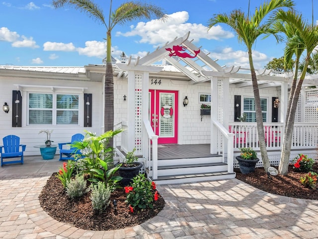 property entrance featuring metal roof and a porch