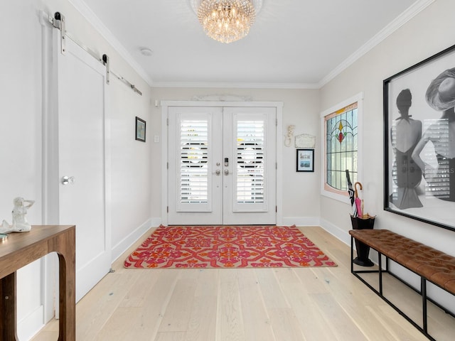 interior space featuring light wood-type flooring, a barn door, plenty of natural light, and french doors