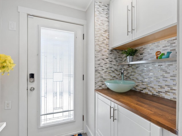 doorway to outside with a sink