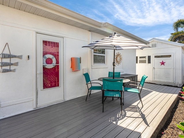 wooden terrace featuring outdoor dining area