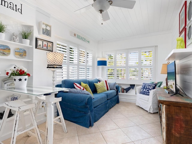 living area with ornamental molding, wooden ceiling, a wealth of natural light, and tile patterned floors