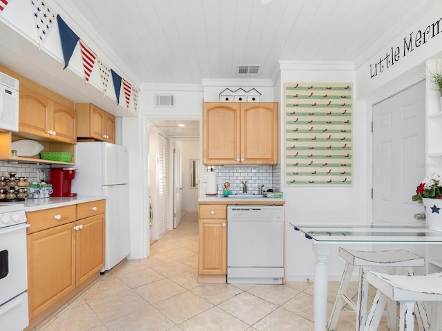 kitchen with white appliances, light tile patterned floors, visible vents, ornamental molding, and light countertops