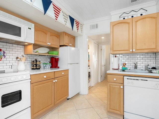 kitchen with white appliances, visible vents, light countertops, and a sink