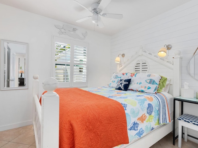 bedroom featuring ceiling fan, light tile patterned flooring, and baseboards