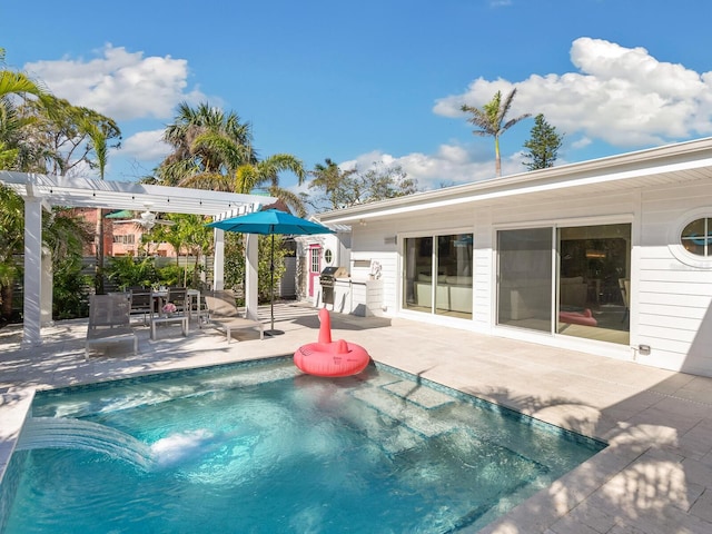 view of pool with a patio area, a grill, and a pergola