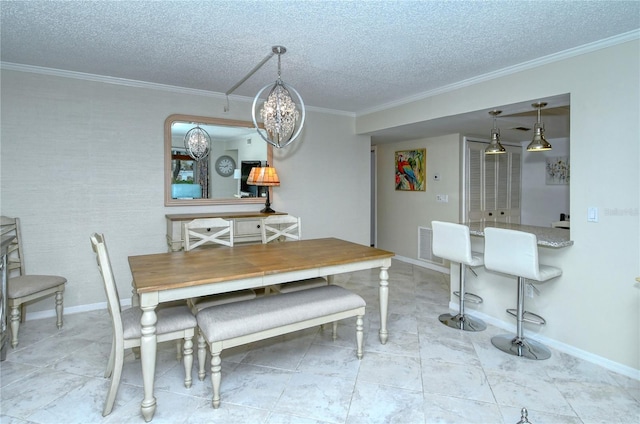 dining area featuring a textured ceiling, ornamental molding, and baseboards