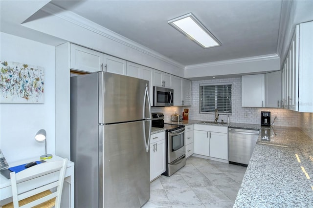 kitchen with decorative backsplash, light stone counters, stainless steel appliances, and crown molding