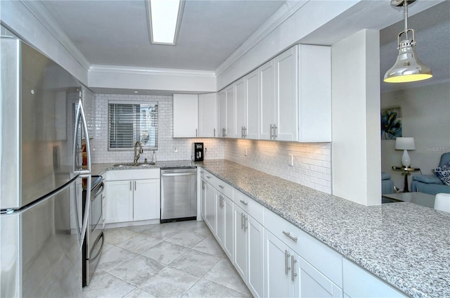 kitchen with light stone counters, crown molding, stainless steel appliances, white cabinetry, and a sink