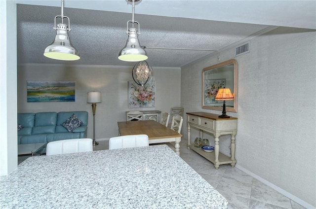 tiled dining space with a textured ceiling, baseboards, visible vents, and crown molding