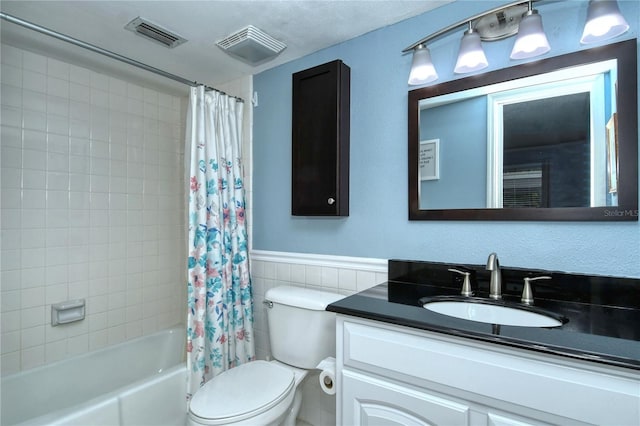 bathroom with shower / bathtub combination with curtain, visible vents, vanity, and toilet