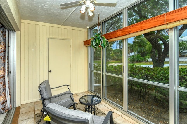 sunroom featuring ceiling fan and a healthy amount of sunlight