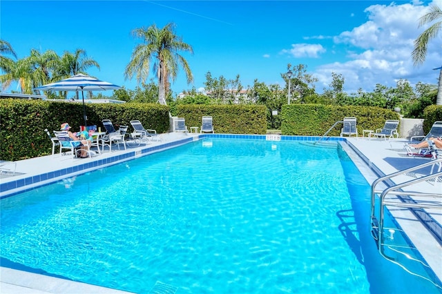 pool featuring a patio area and fence