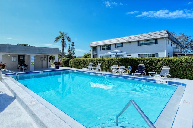 community pool featuring a patio area and fence