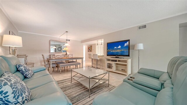 1711 Southwood St Unit 1711, Sarasota, FL 34231 - living room featuring ornamental molding, a textured ceiling, and visible vents