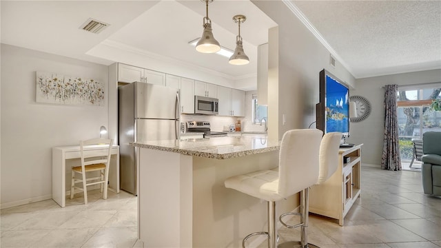 1711 Southwood St Unit 1711, Sarasota, FL 34231 - kitchen featuring a breakfast bar area, tasteful backsplash, light stone counters, a sink, and appliances with stainless steel finishes