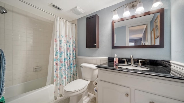 1711 Southwood St Unit 1711, Sarasota, FL 34231 - bathroom featuring visible vents, tile walls, vanity, toilet, and shower / tub combo with curtain