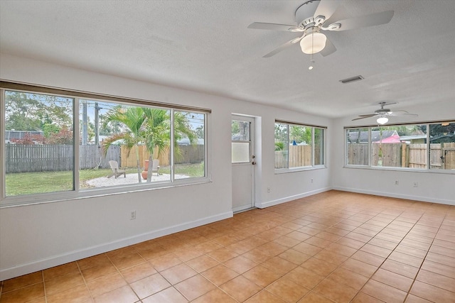 interior space featuring ceiling fan and visible vents