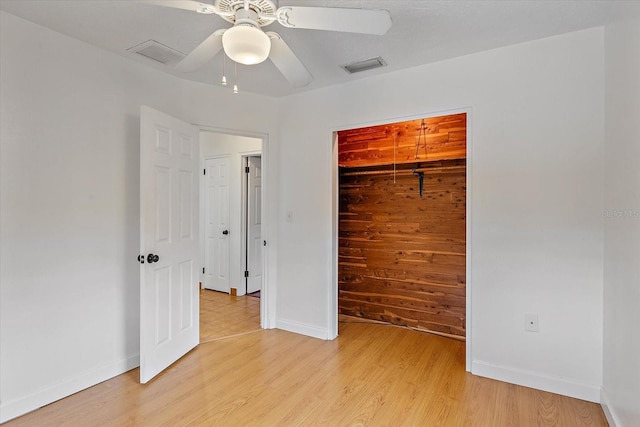 unfurnished bedroom featuring light wood-type flooring, visible vents, and baseboards