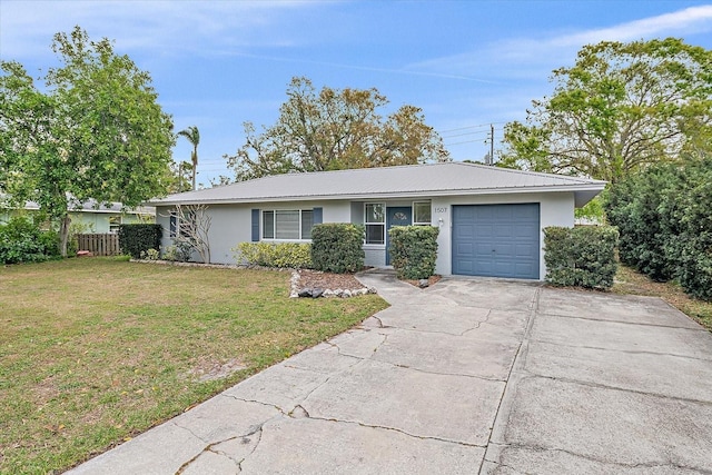 ranch-style house featuring a garage, concrete driveway, metal roof, a front lawn, and stucco siding