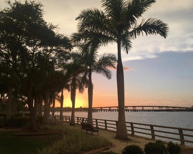 exterior space with a water view and fence