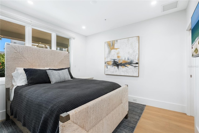 bedroom featuring visible vents, recessed lighting, wood finished floors, and baseboards