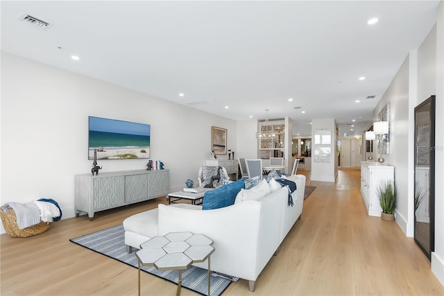 living area featuring recessed lighting, visible vents, and light wood-style flooring