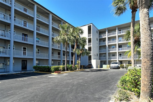 view of building exterior with uncovered parking