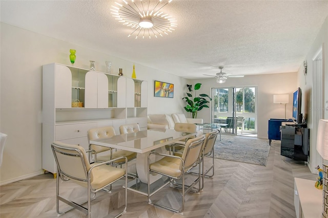 dining area featuring a ceiling fan, a textured ceiling, and baseboards