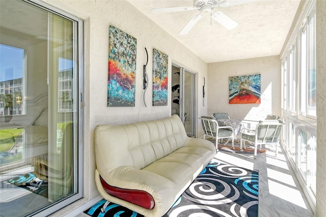 sunroom featuring a ceiling fan