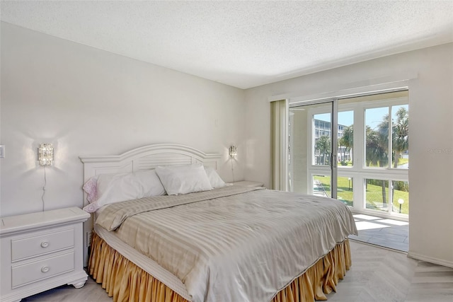 bedroom featuring a textured ceiling and access to exterior