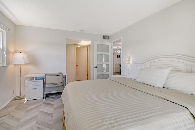 bedroom featuring visible vents and baseboards