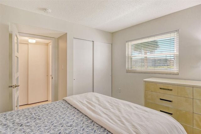 bedroom with a closet and a textured ceiling