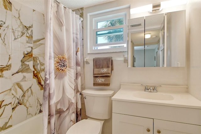 bathroom featuring a textured ceiling, toilet, shower / bath combo with shower curtain, and vanity